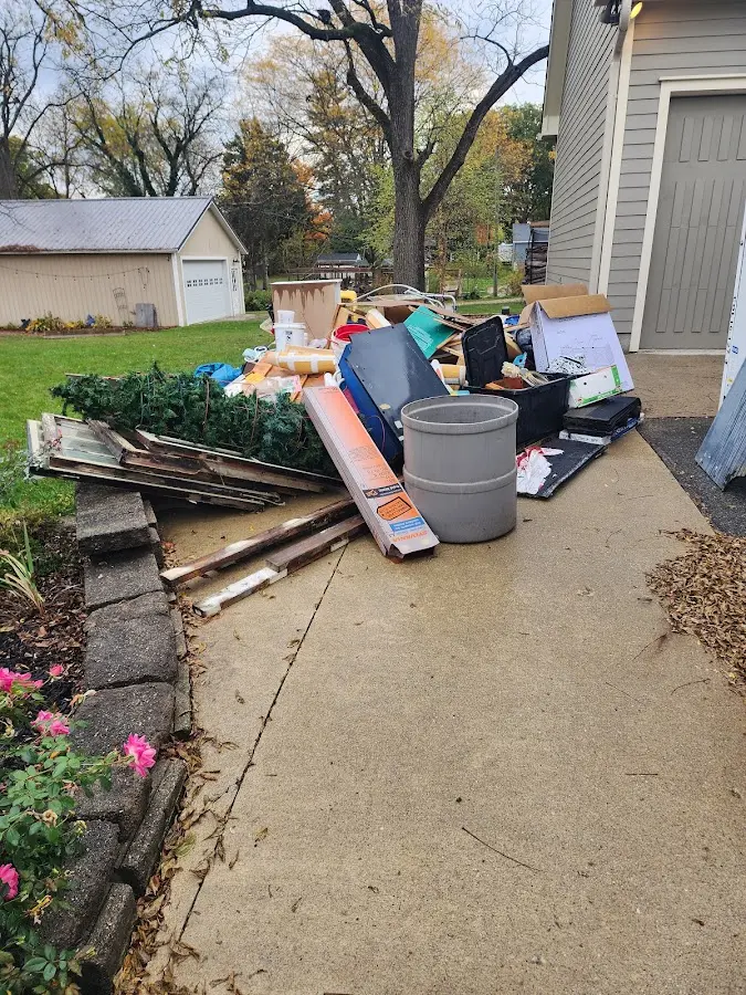 Dumpster being loaded with debris for Roofing Dumpster Rental in Center